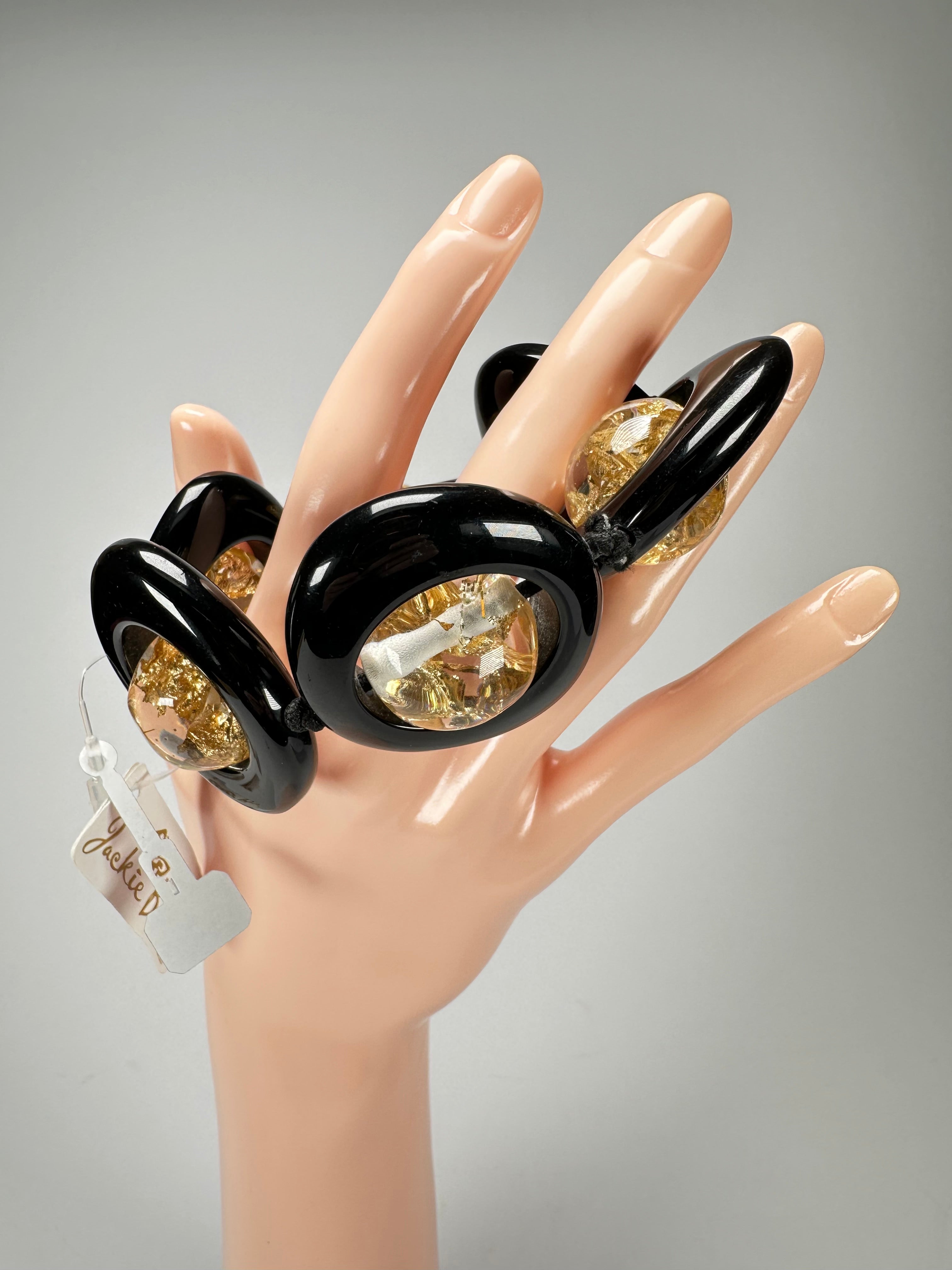 Jackie Brazil "Saturn" Black & Gold Flakes Disc & Ball Elastic Bracelet ( B0052 )