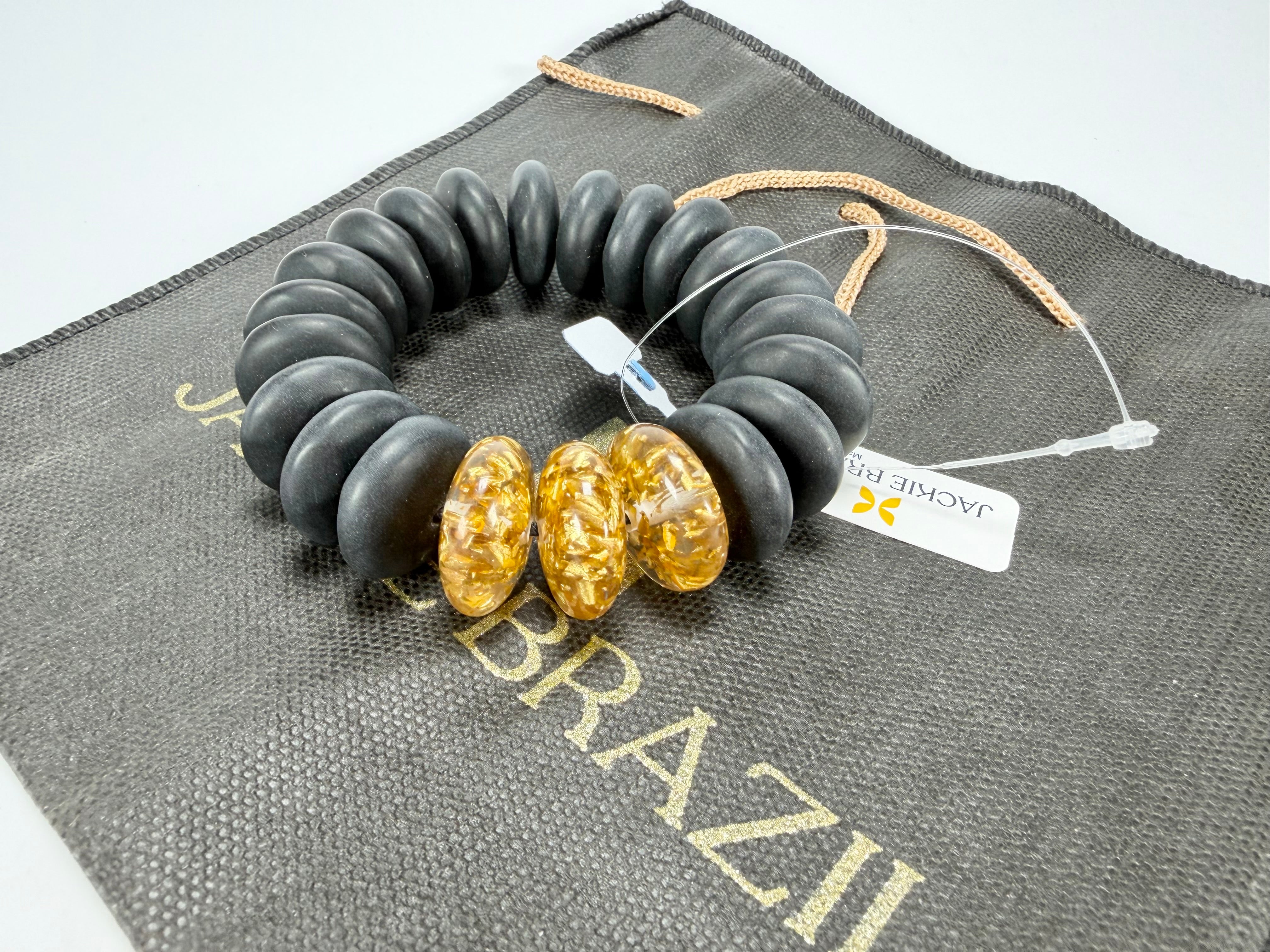 Jackie Brazil "Ana" Black Matt & Gold Flakes Mix Elasticated Wheels Resin Bracelet ( B0910 )