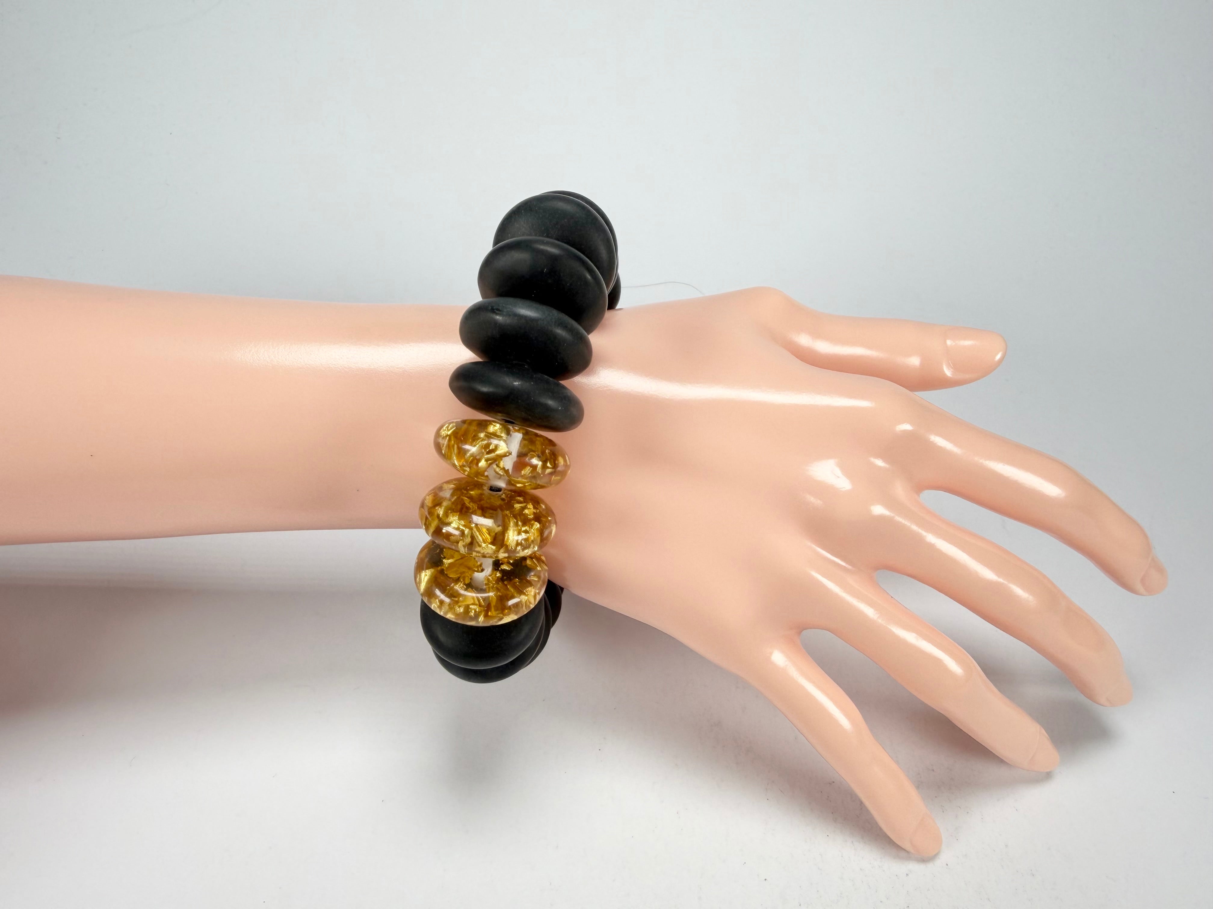 Jackie Brazil "Ana" Black Matt & Gold Flakes Mix Elasticated Wheels Resin Bracelet ( B0910 )