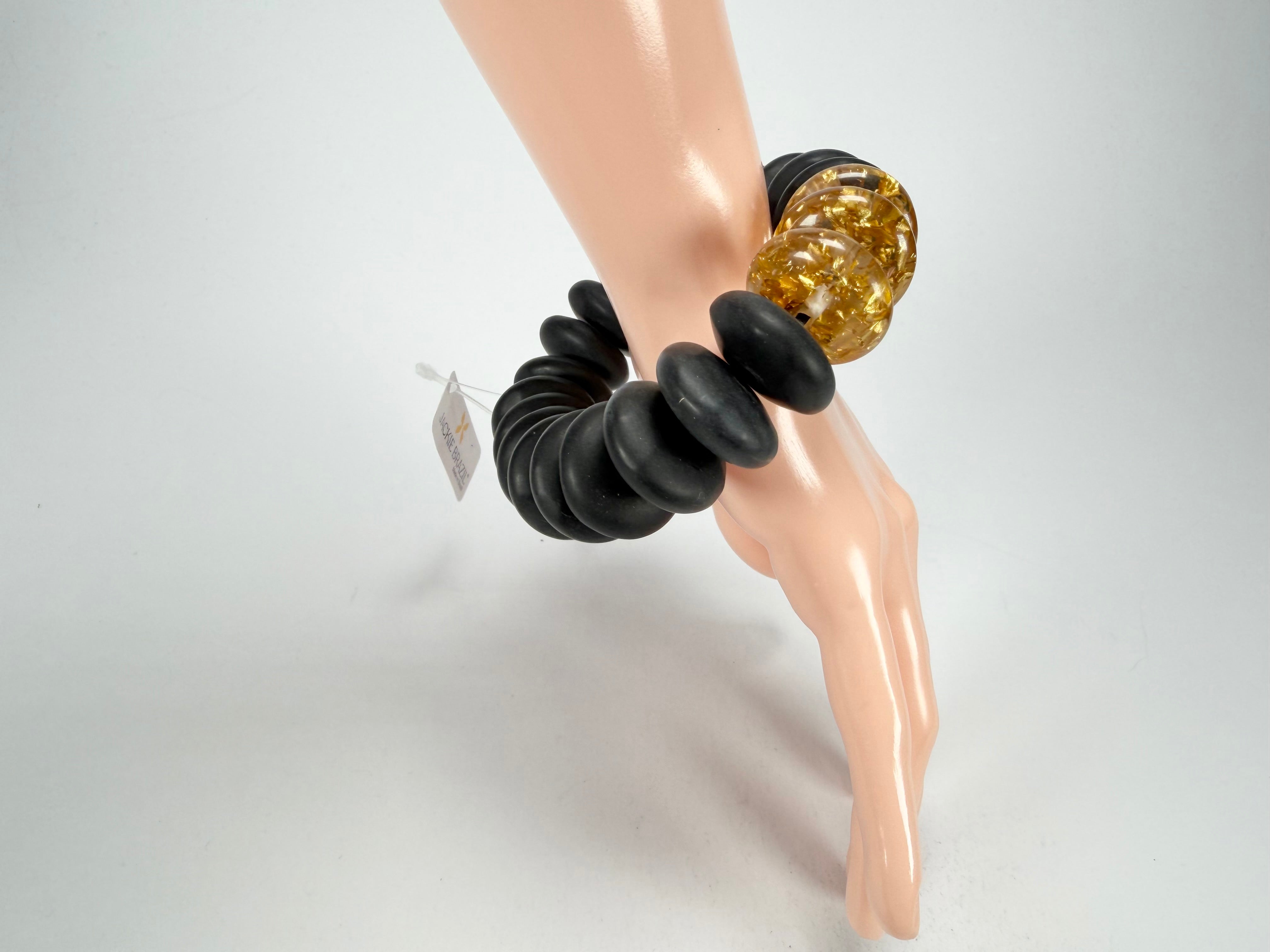 Jackie Brazil "Ana" Black Matt & Gold Flakes Mix Elasticated Wheels Resin Bracelet ( B0910 )