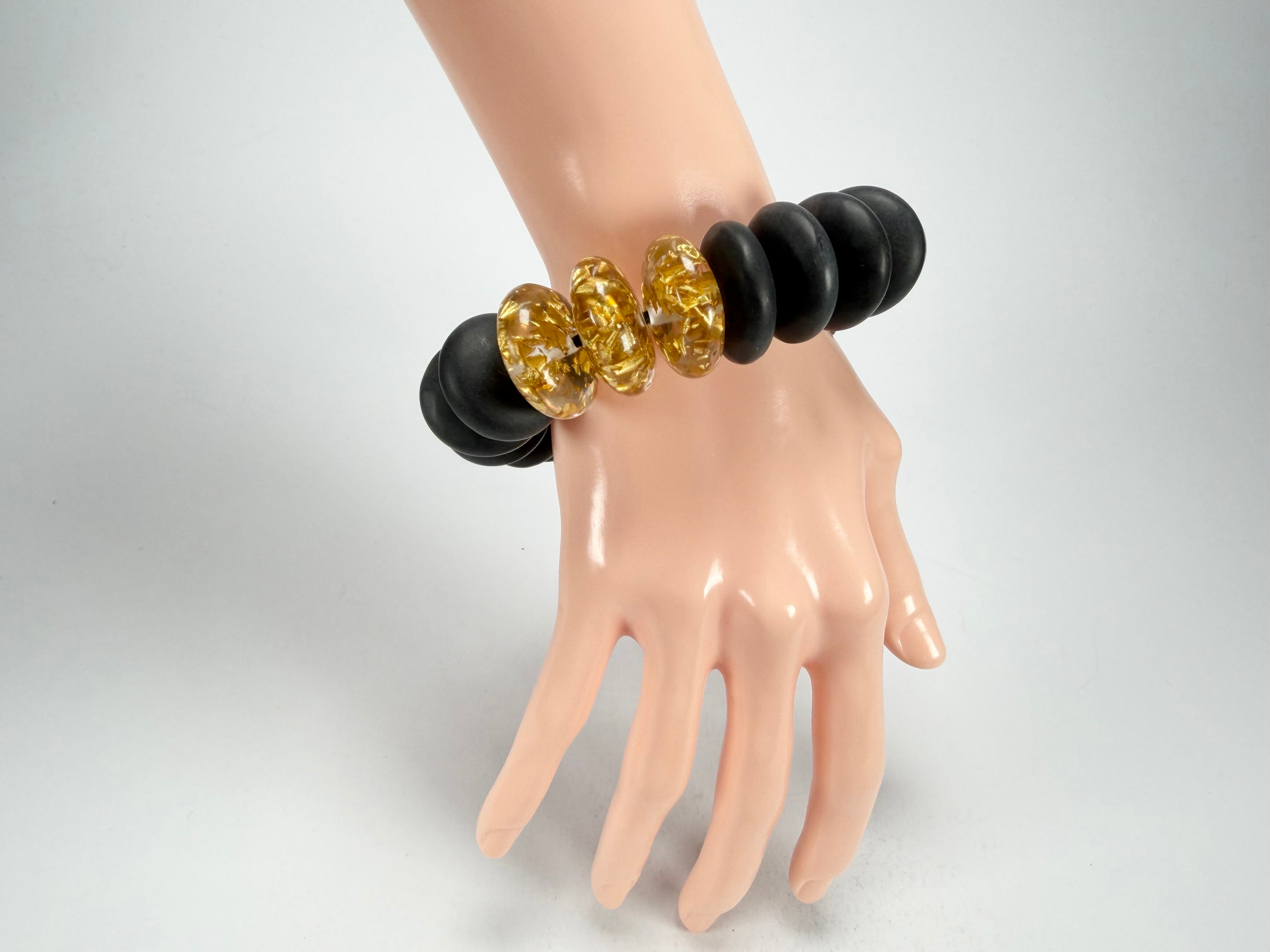 Jackie Brazil "Ana" Black Matt & Gold Flakes Mix Elasticated Wheels Resin Bracelet ( B0910 )