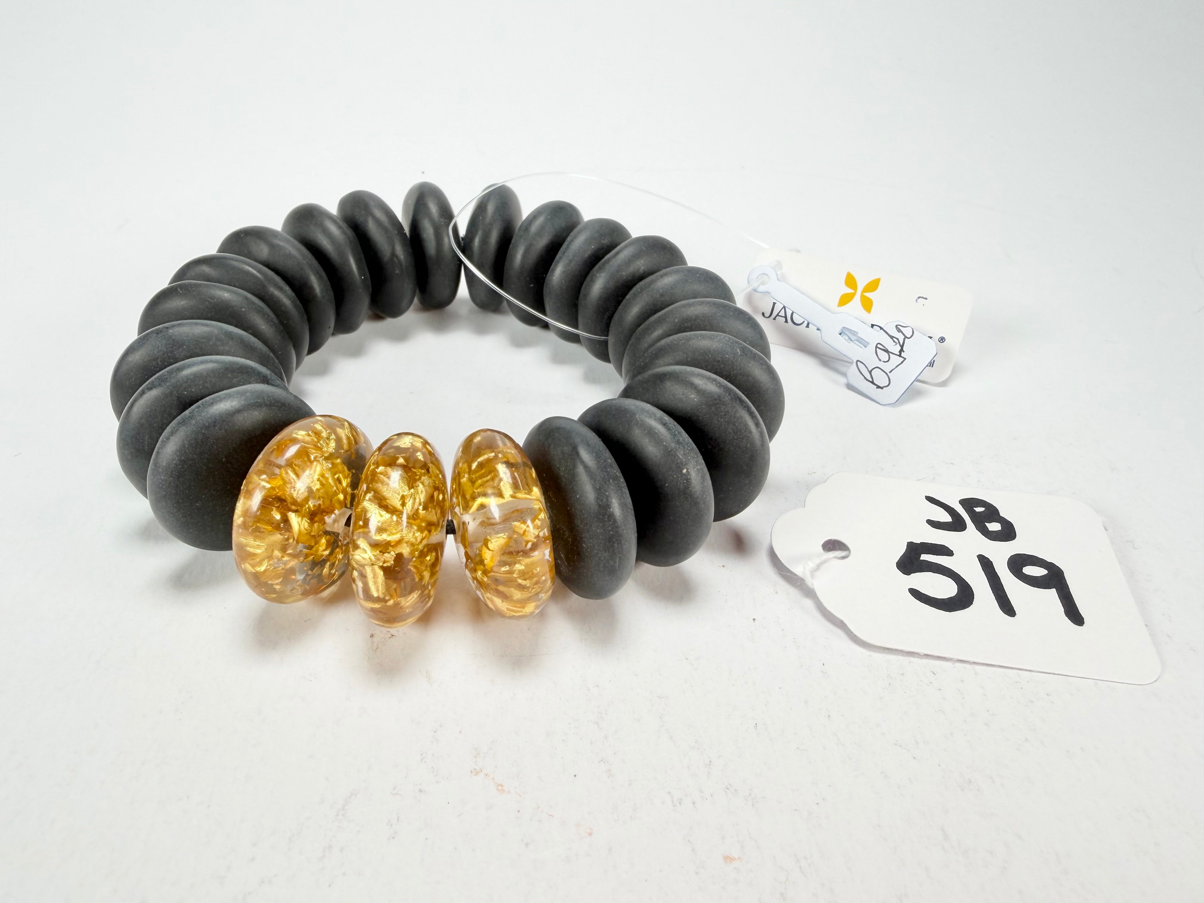 Jackie Brazil "Ana" Black Matt & Gold Flakes Mix Elasticated Wheels Resin Bracelet ( B0910 )