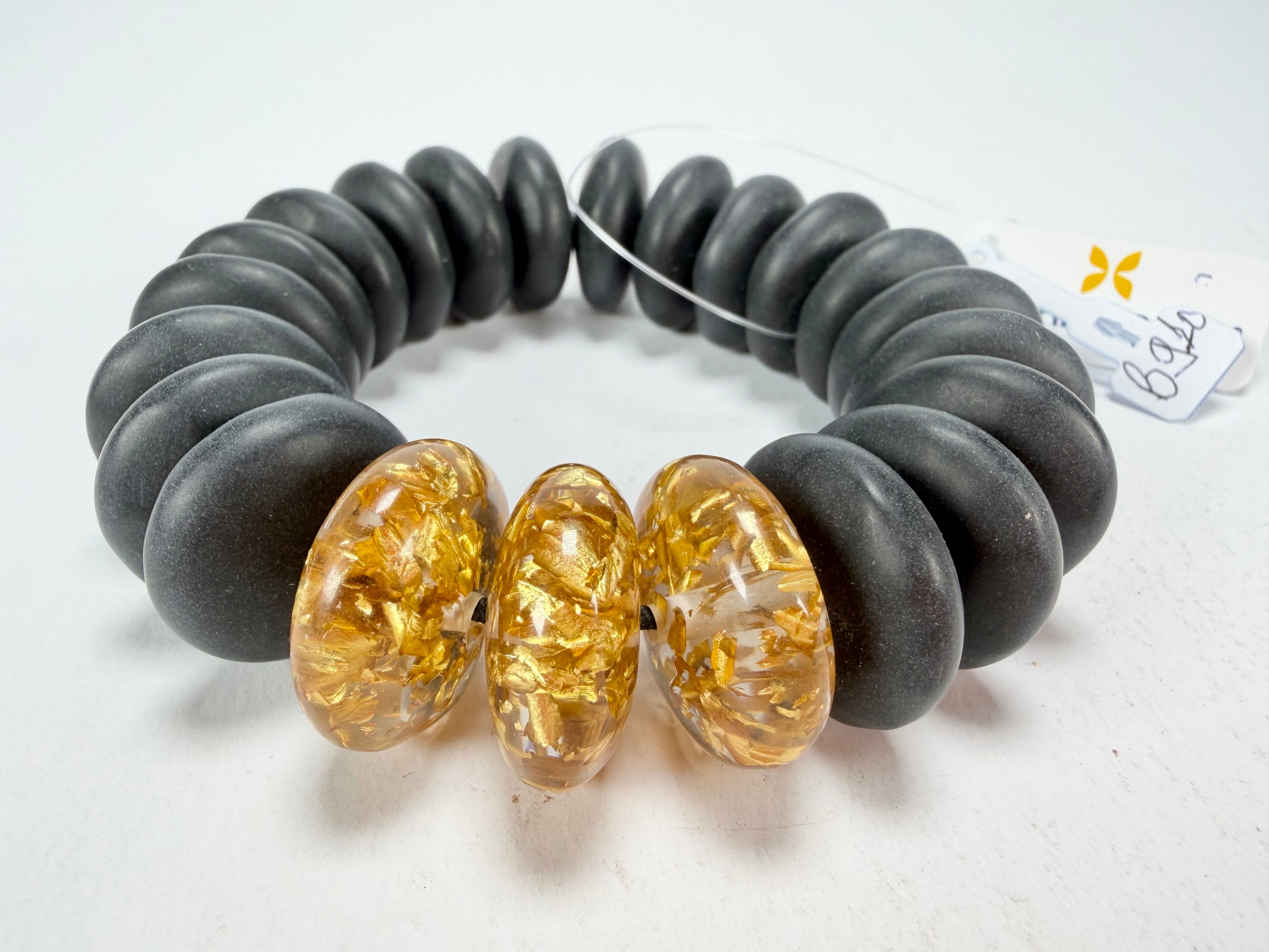 Jackie Brazil "Ana" Black Matt & Gold Flakes Mix Elasticated Wheels Resin Bracelet ( B0910 )